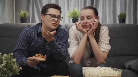 A young couple of two friends react to watching movie. discussing and talking Video stock 123496291