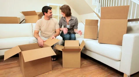 Young Couple Unpacking House Moving Cartons Stock Footage