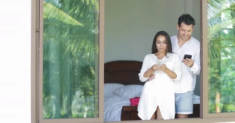 Young Couple Use Cell Smart Phones Talking Looking In Window Chatting Online Stock Footage