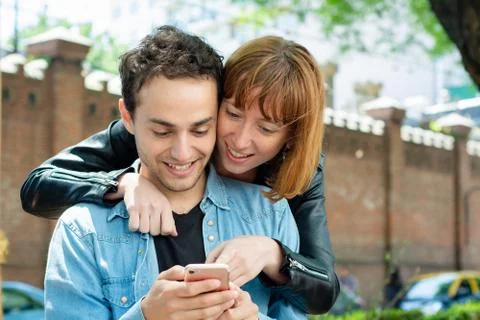 Young couple using application on smartphone Stock Photos