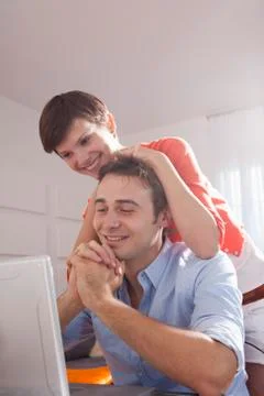 Young Couple using Computer, Miami Beach, Florida, USA 写真素材