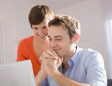 Young Couple using Computer, Miami Beach, Florida, USA 写真素材
