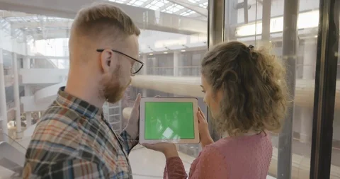 Young couple using digital tablet at shopping mall in elevator Stock Footage 126574149