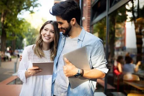 Young couple using a digital tablet together and smiling Stock Photos