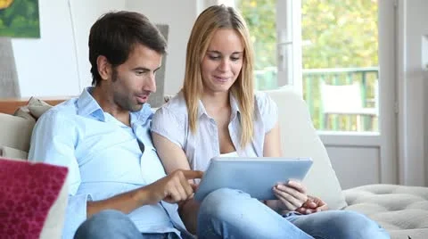 Young couple using electronic tablet at home Stock-Footage 14833014