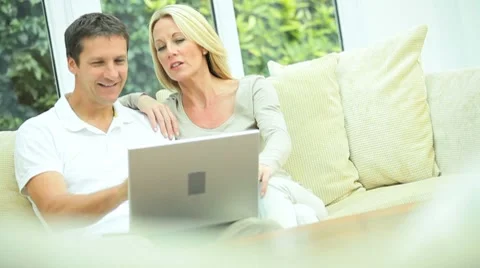 Young Couple Using Home Laptop Stock Footage 8829354