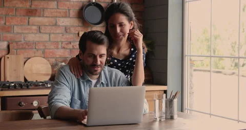 Young couple using laptop buying on-line services Stock Footage 148032585