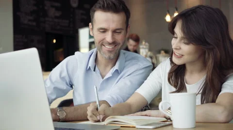 Young couple using laptop in a cafe 動画素材 64654978