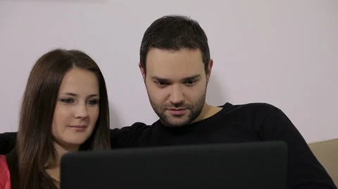 Young couple using laptop Stock Footage 45096595