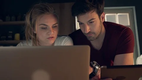 Young couple using laptop Stock Footage 74515447
