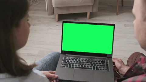 Young couple using laptop looking at green screen. Online shopping. 4K, UHD Stock Footage 132066254