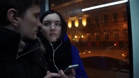 Young couple using smart phone looking at screen during bus ride Stock Footage 83873578