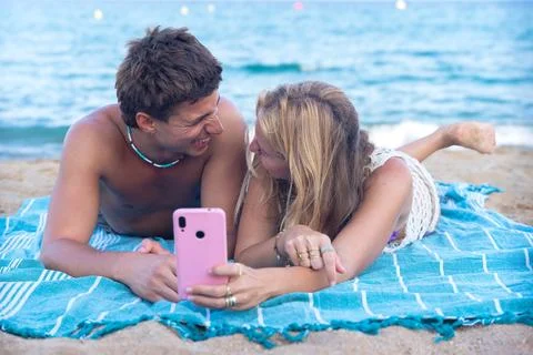 Young couple using smartphone app outdoors. Stock Photos