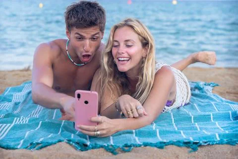 Young couple using smartphone app outdoors. Stock Photos