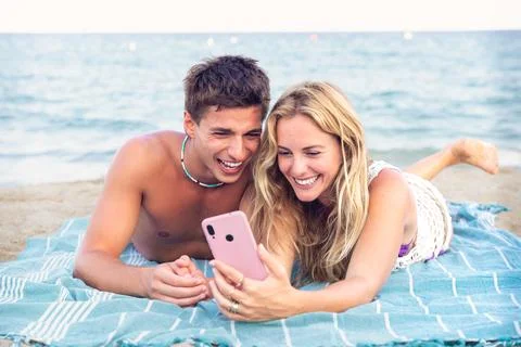 Young couple using smartphone app outdoors. Stock Photos