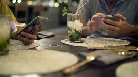 Young couple using smartphone in cafe, focus on hands, 4K Stock Footage 69180258