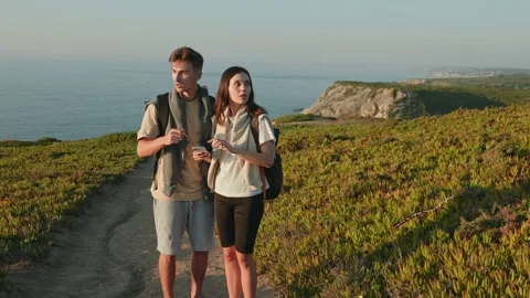 Young Couple Using Smartphone for Navigation on Hike Stock Footage 272473044