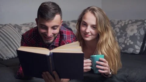 Young Couple Using Tablet and Read the Book Stock-Footage 70102487