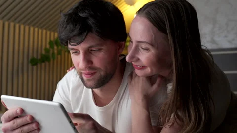 Young couple using tablet on bed in bedroom late at night Stock-Footage 148465075