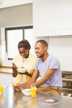 Young couple using tablet at breakfast Stock-Fotos