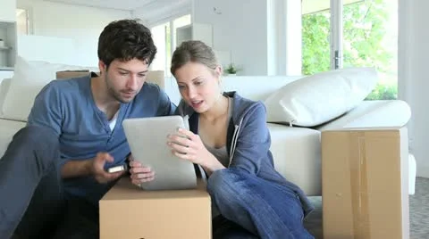 Young couple using tablet to find transport company Stock Footage 14829530
