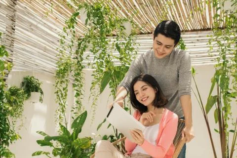 Young couple using tablet at the garden. Stock Photos