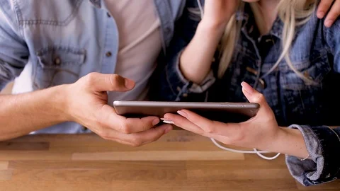 Young Couple Using Tablet Listen To Music And Drinking Coffee Stock Footage 89828643