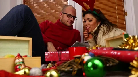 Young couple using tablet pc. Christmas time. 50 fps. Stock Footage 57369220