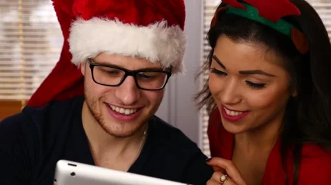 Young couple using tablet pc. Christmas time Stock Footage 57369588