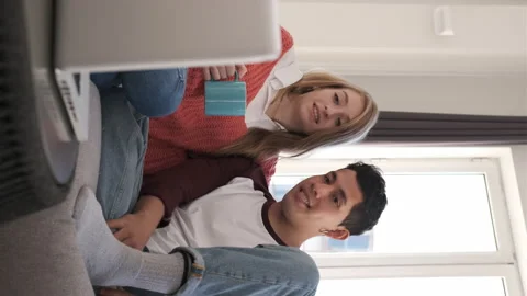 Young couple on a video call with their laptop while staying at home. Vertica Stock Footage 148473247