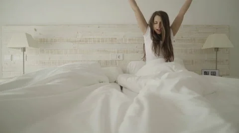 Young couple waking up in bed Stock Footage 62680366