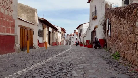 Young couple walk down a cobblestone street in the magical town while talking Stock Footage 305800951