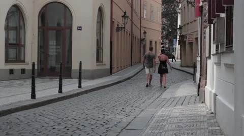 Young couple walk down a narrow street Stock Footage 40968789