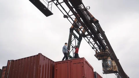 Young couple walk on a freight containers Stock Footage 91773481