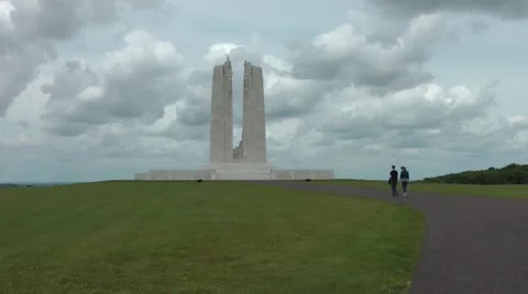 Young couple walk up path toward Vimy Ridge WW1 Canadian Memorial to Missing Stock Footage