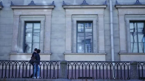 Young couple walking along Saint Petersburg past beautiful buildings. slow Stock Footage 78893501