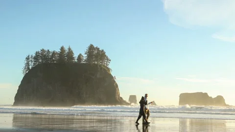 Young couple walking along Second Beach at La Push, WA Stock Footage 215916986