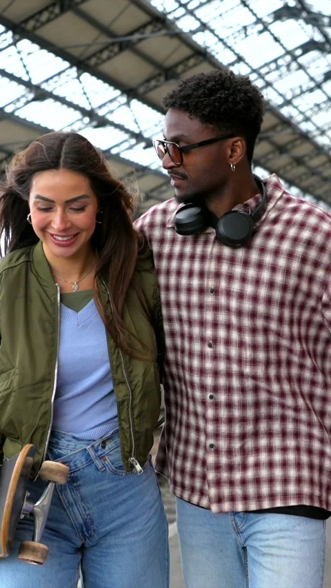 Young couple walking and having fun at train station Stock Footage 311809588