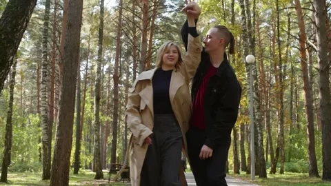 Young couple walking and having fun in a park Stock Footage 314631492