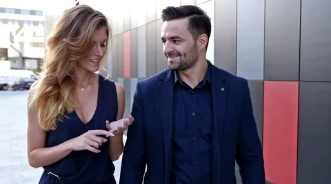 Young couple  walking and talking in front of modern building. Romantic meeting. Stock Footage 56304740