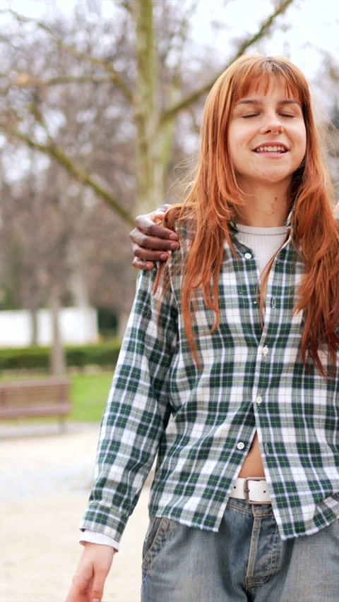 Young couple walking and talking in park Stock Footage 308912209