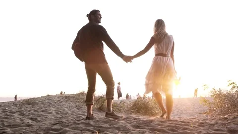 A young couple walking on a beach Stock-Footage 76222696