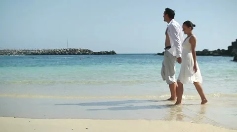 Young couple walking on the beach, slow motion HD Stock Footage 10901784