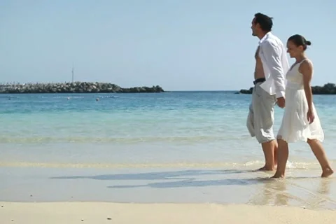 Young couple walking on the beach, slow motion NTSC Stock Footage 10901785