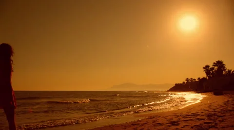 Young couple walking on beach in sunset Stock Footage 43618045