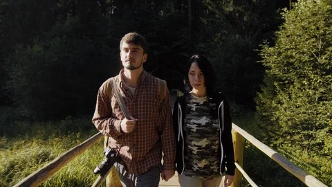 Young couple walking on a bridge, back view of Stock Footage 90018824