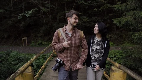 Young couple walking on a bridge Stock Footage 90011855