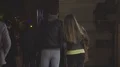 Young couple walking in crowd down street at night, night city life, slow-motion HD Footage