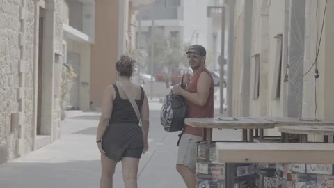 A young couple walking down the street in Paphos, Cyprus 動画素材 344056721