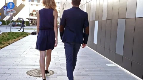 Young couple  walking in front of modern building. Legs close up Stock Footage 55892904